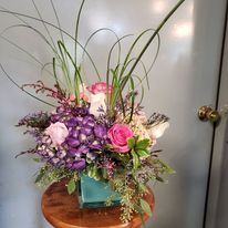 Perfect for a desk or front counter. This design is widely popular as everyone enjoys beautiful hydrangea and roses! These designs seem to last longer as the stems are short and the water doesn't have to travel as far to the top of the bloom! We call this the 